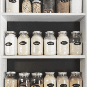 clearly labeled glass canning jars in an organized pantry
